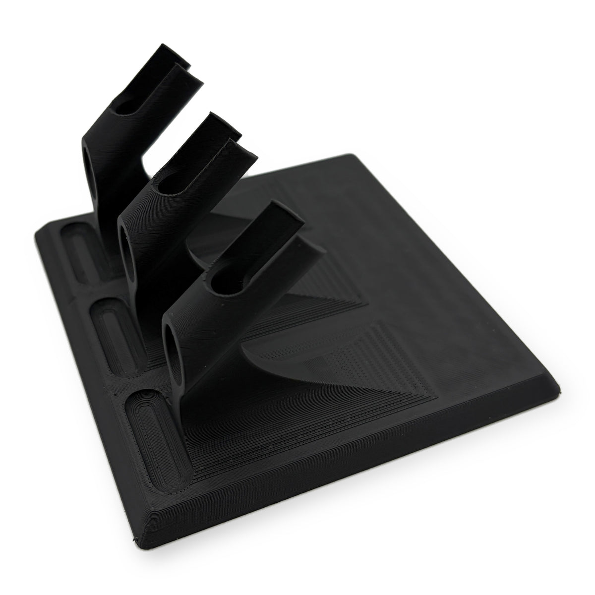 Three airbrush desktop stand in matte black, three angled cradles on a wide flat base