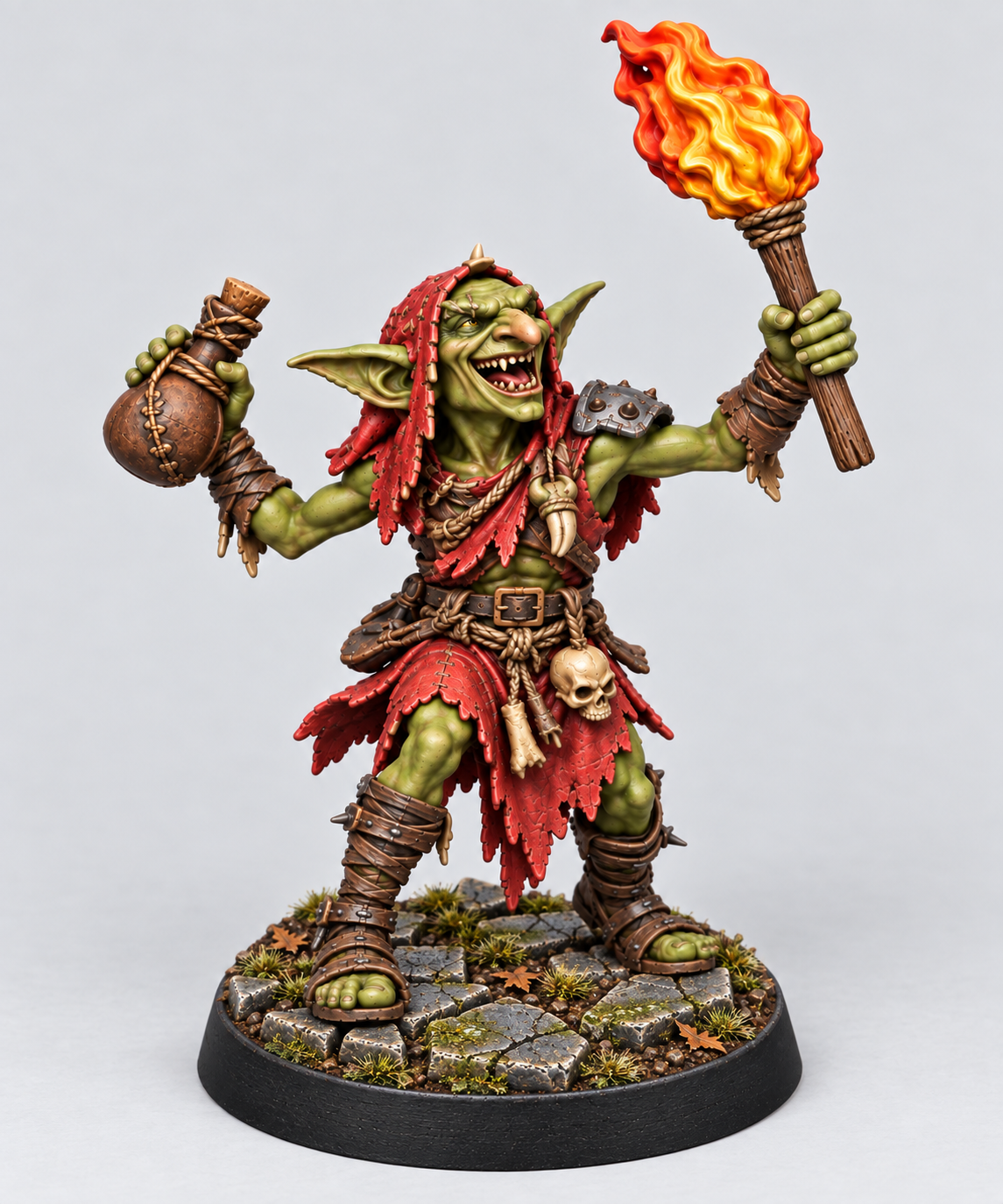 Goblin Firestarter painted green and red with raised flaming torch on Broken Dungeonstone; supplied unpainted.