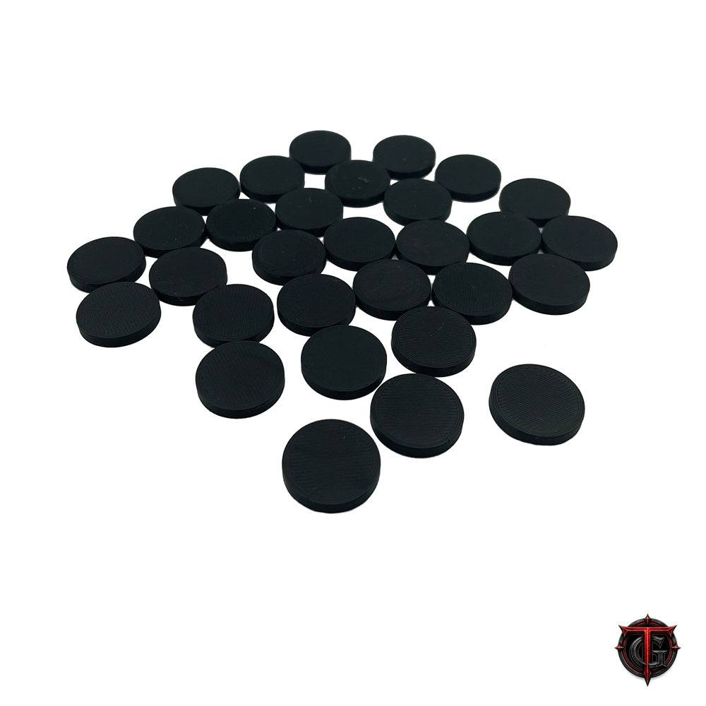 Pile of 3D printed 0.75 inch black circular miniature bases with hollow bottoms